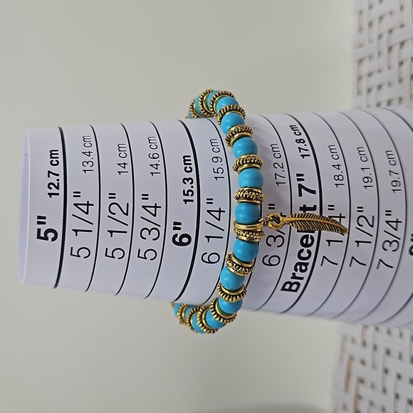 Handmade blue howlite and gold spacer bead stretch bracelet with a gold feather - Picture 3 of 3